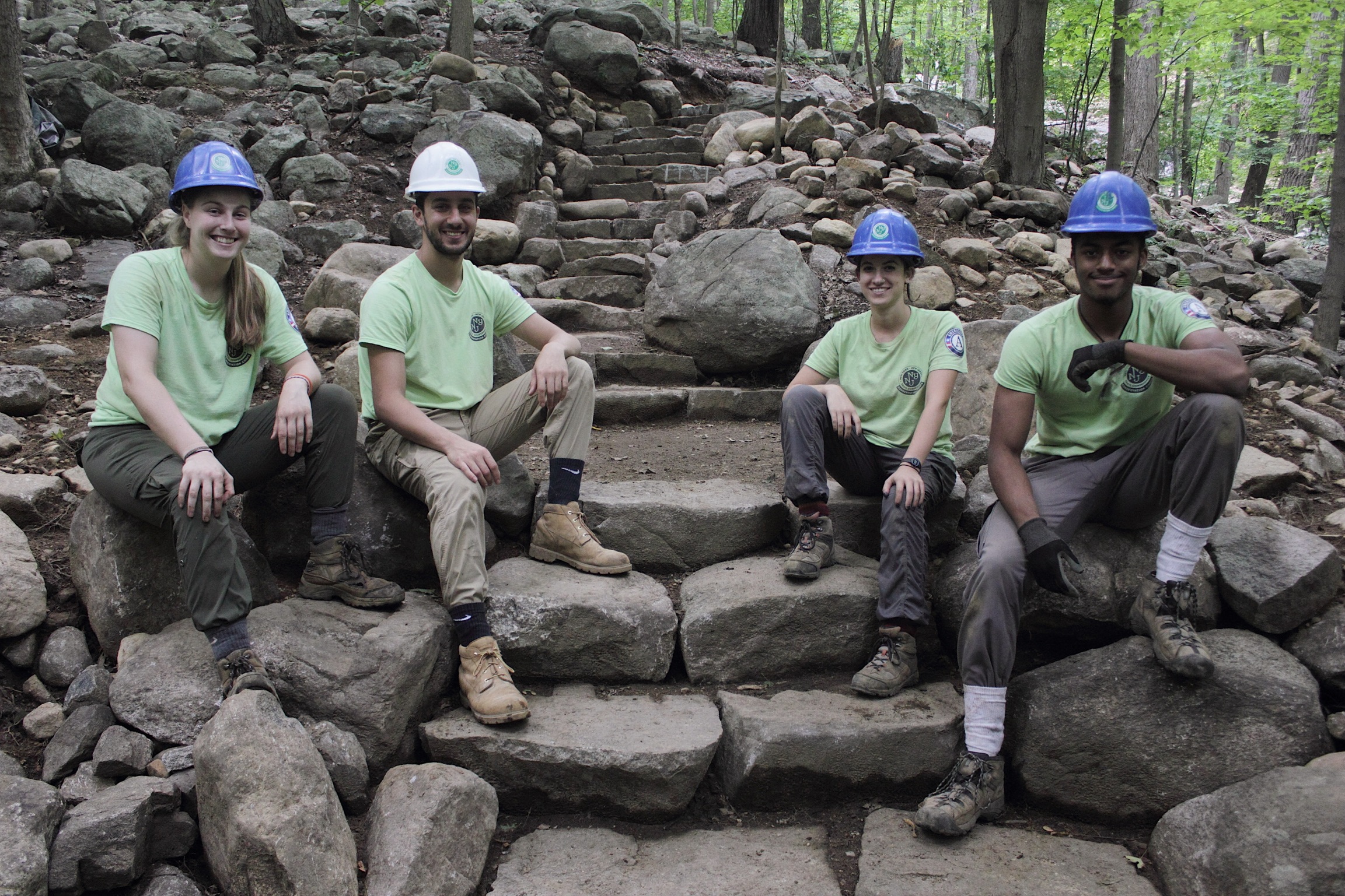 Sweet Water Trail Crew proudly sitting on their stone steps built on the Ramapo Valley County Reservation Vista Loop. Photo by Brayden Donnelly.